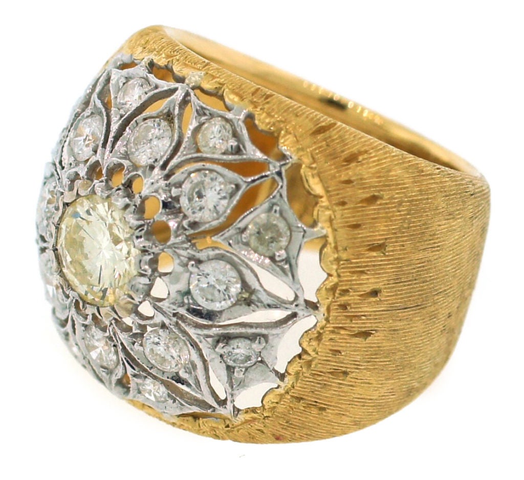 Stunning signature ring created by Mario Buccellati in Italy in the 1960's. Beautiful white gold round openwork encrusted with round diamonds and famous Buccellati satin finish on the yellow gold part of the ring - classy, stylish, timeless.<br
