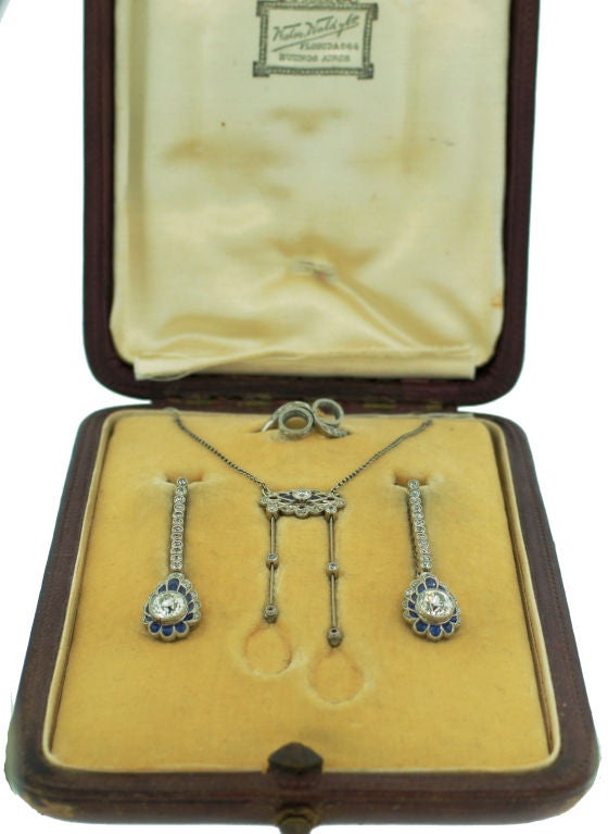 Delicate and feminine Edwardian interchangeable set consisting of a ring, a necklace and a pair of earrings created in Europe in the 1910's. It is made of platinum, encrusted with Old European cut and rose cut diamonds and accentuated with blue
