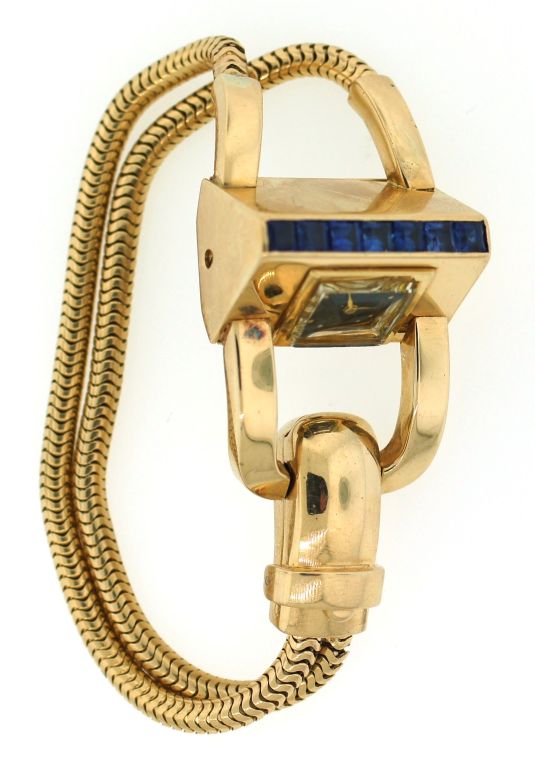 Chic Retro bracelet / watch created by J.E. Caldwell in the 1940's. Unusual shape, perfect proportions and sapphire accent make the bracelet a conversational piece.<br />
The watch has a mechanical movement and is manual wind. The watch is in good