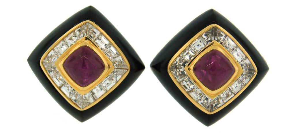Bold and colorful clip-on earrings created by Bulgari in Italy in the 1980's. They feature a square ruby cabochon in the center, pre-cut diamonds and black onyx set in yellow gold.

Posts can be added if needed.

They are slightly under 3/4