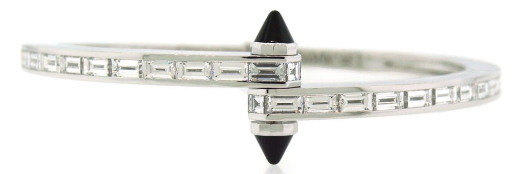 Stunning exquisite version of Cartier LOVE Collection that is not made any longer. Super quality baguette cut diamonds set in white gold and accentuated with black onyx are the highlights of this stylish bangle.<br />
The inner dimensions of the