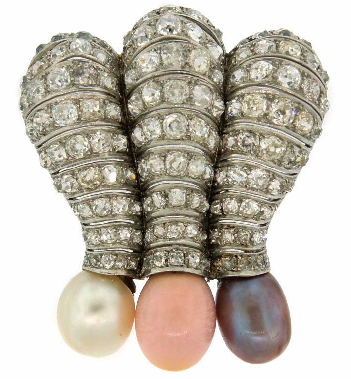 Unique and rare brooch created in France in the 1930's.
It is made of platinum encrusted with Old European cut diamonds and features three natural pearls - white 12.49 mm, conch 10.55 mm, and chocolate 10.87 mm. The pearls come with a GIA Natural
