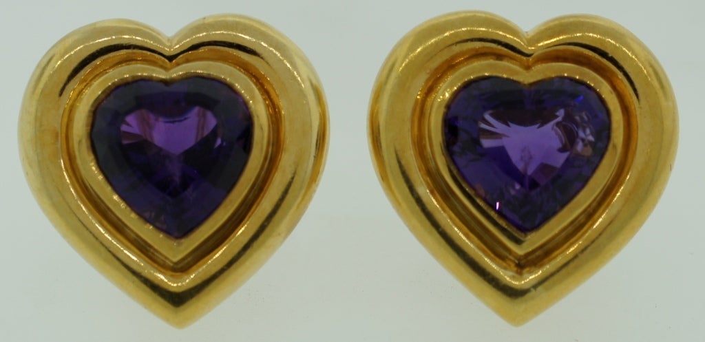 Bold and colorful earrings created by Paloma Picasso for Tiffany & Co. in 1983. Heart-shape gorgeous deep purple amethyst is tastefully framed in solid 18 karat yellow gold. The earrings are clip-on but posts can be added if needed. They are stamped