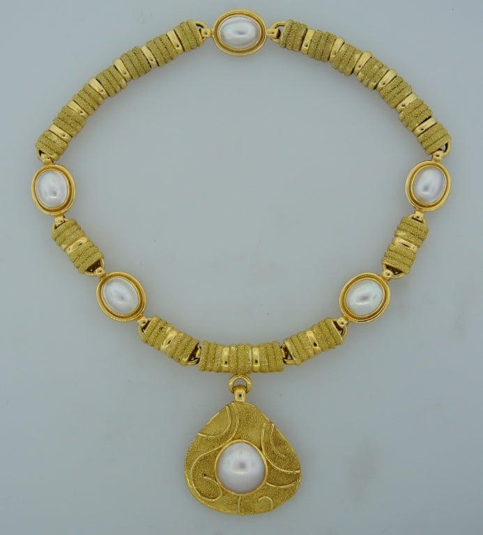 This bold and elegant necklace was created by Elizabeth Gage in the 1970's. Her designs are very distinctive as she brings elements of the past into a contemporary form. This necklace is a perfect example! The necklace is made of yellow gold and