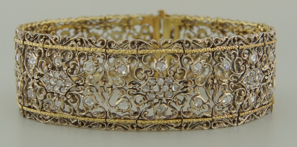 Stunning old Mario Buccellati bracelet created in Italy in the 1940's. It features rose cut diamonds set in delicate white gold filigree openwork and accentuated with yellow gold trim. The bracelet is amazing! - important yet understated.
It fits