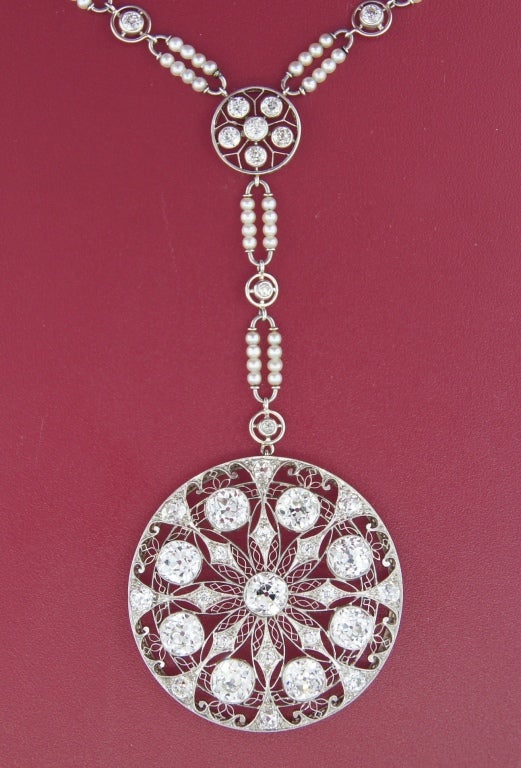 Important Edwardian necklace created in Europe in the 1910's. Nine approx. 0.90-ct each Old European cut diamonds, delicate filigree openwork and seed pearl accents are the highlights of this beautiful piece.
The pendant is 1-5/8