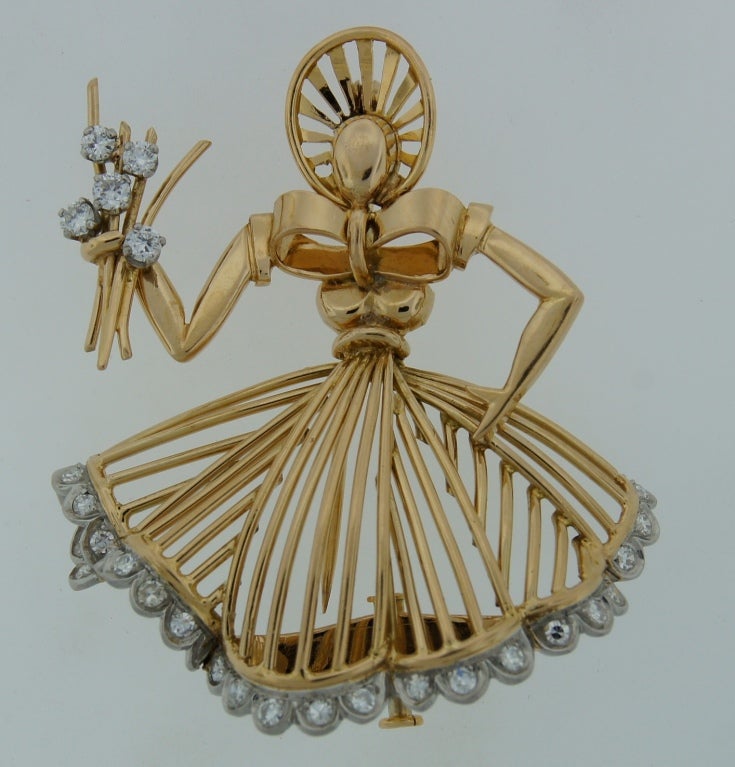 Fabulous and cute Retro brooch created by Cartier in Paris. It is designed as a mid-18th century dressed up woman holding flowers.
Definitely unique and conversational piece! The brooch is made of yellow gold, the woman's dress and the flowers are