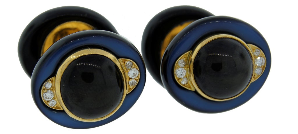 A pair of bold and colorful cufflinks made by Groene et Darde, a jewelry workshop that worked exclusively for Suzanne Belperron at that time. The cufflinks were created in France in 1970-1974. The pair features black star sapphire set in yellow gold