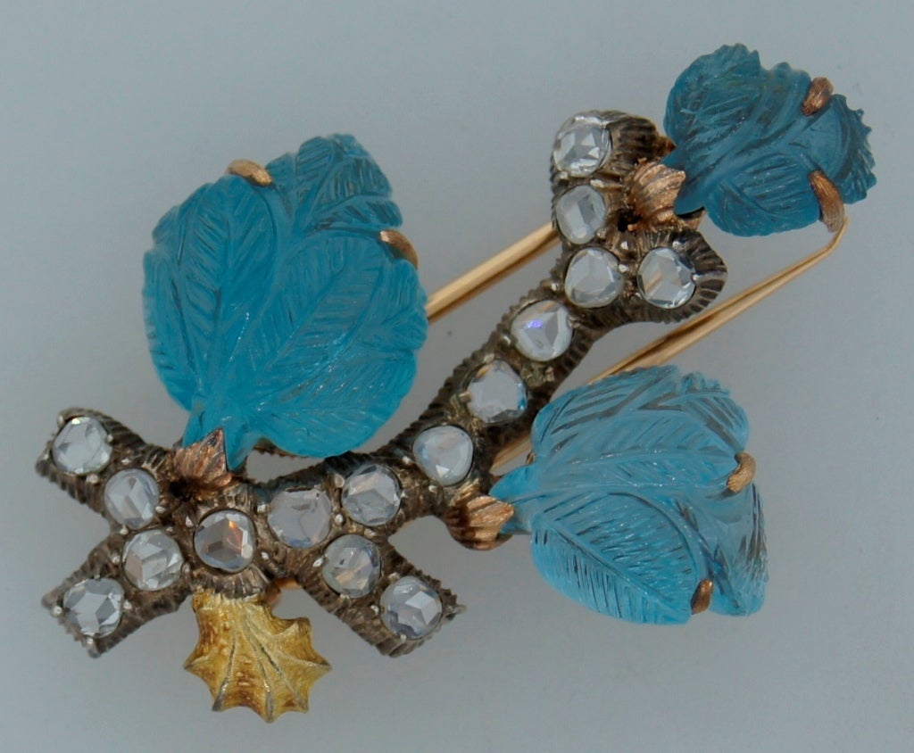 Sensual and sophisticated brooch created by Mario Buccellati in Italy in the 1950's. Designed as a brunch - Buccellati utilized one if his favorite motifs - floral. Made of three tone gold. The piece features carved aquamarine leaves. The brunch is