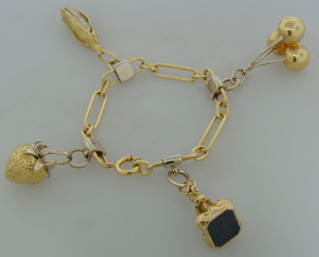 Fun and bold charm bracelet created by Cartier, New York in the 1970's. It is made of 18k yellow and white gold and one charm holds blood stone.
The bracelet fits up to 7.5