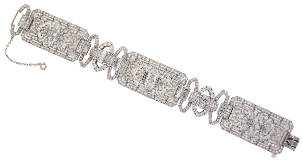 Stunning Art Deco bracelet with elaborate design, strong geometrical pattern and various diamond shapes. Created in the 1920's - 30's. Made of platinum and set with round, marquise, baguette, half-moon, pear-shape and emerald cut diamonds. Features
