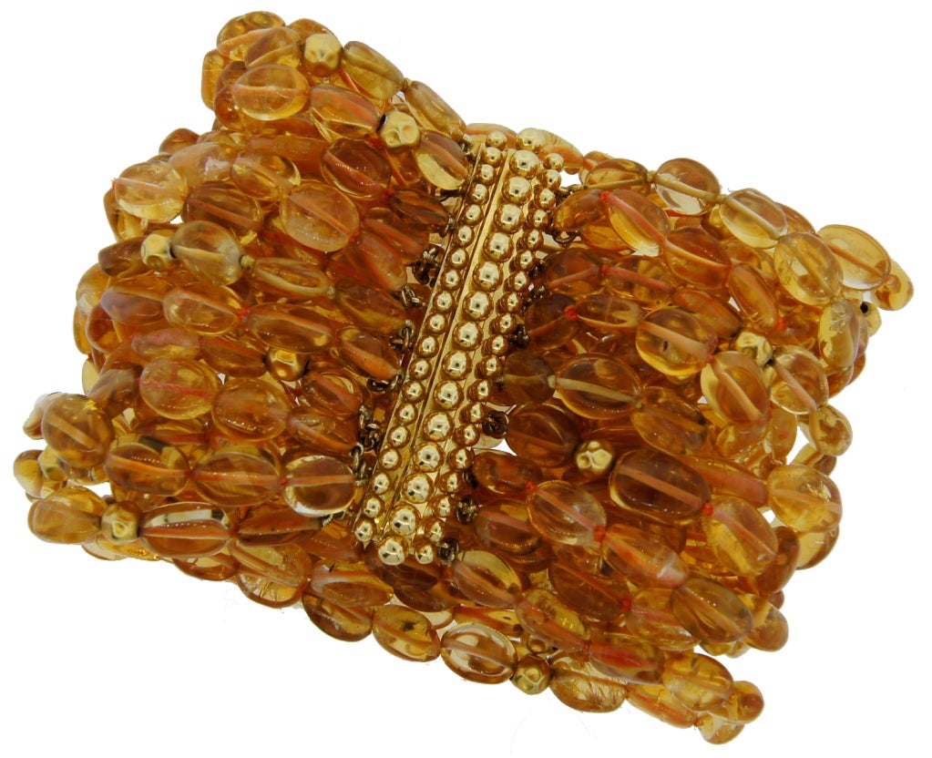 Lovely sunny bracelet created by Verdura in 2001. Has twenty strands of citrine beads, forty 20k yellow gold beads on an 18k yellow gold beaded bar clasp. This style beaded bar clasp was made just a few times.
The bracelet fits up to 7