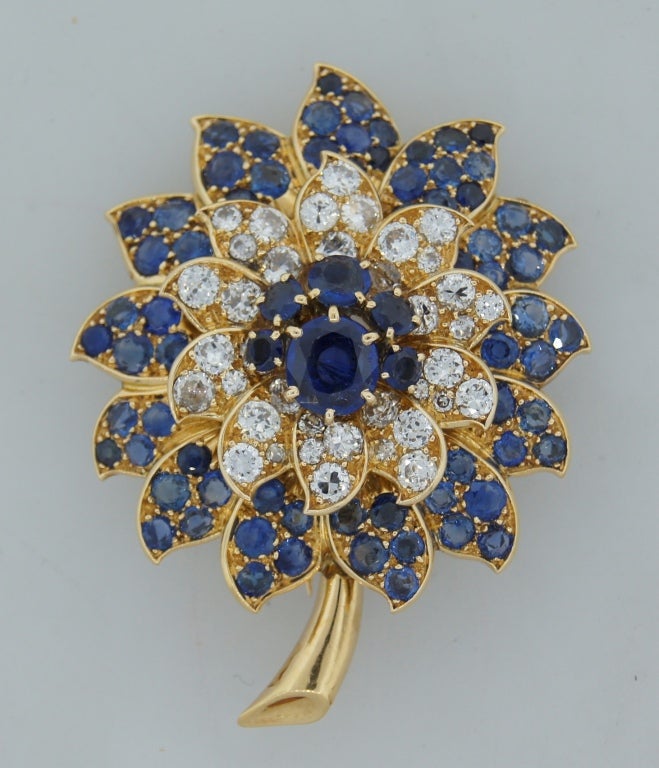 French chic and feminine flower brooch created by Rene Boivin. Made of yellow gold and studded with round sapphires and diamonds.
Makes a tasteful accent to a casual and dressy outfit.
There are French gold hallmark and Boivin maker's mark.