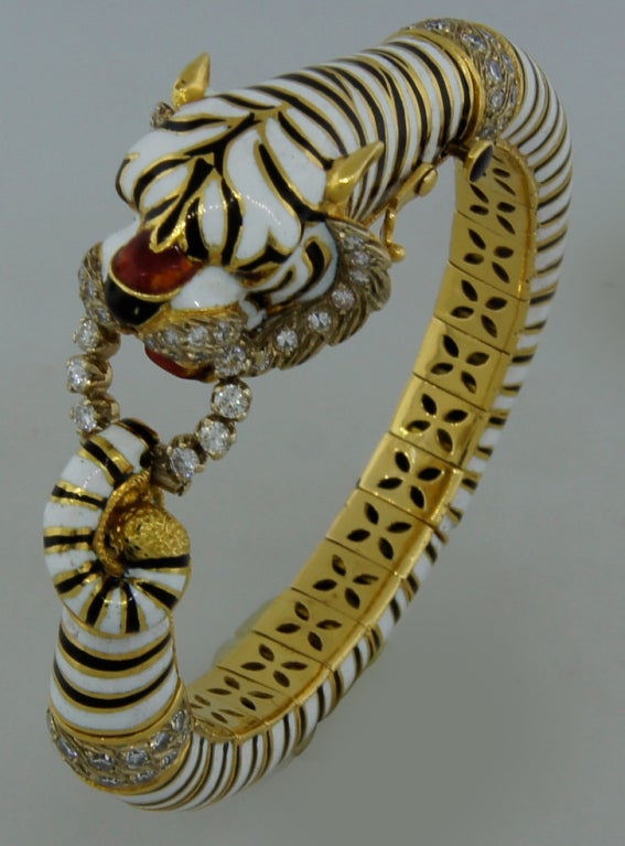 Stunning tiger bangle bracelet created by Pierino Frascarolo in Italy in the 1960's. Made of yellow gold, black, white and red enamel and set with round diamonds.
Fits up to 6.5