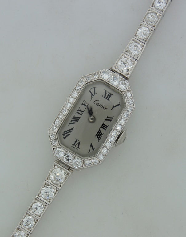 Elegant classy Cartier lady's watch made of platinum and studded with round diamonds. Mechanical movement, 18 jewels. Fits up to 6.5