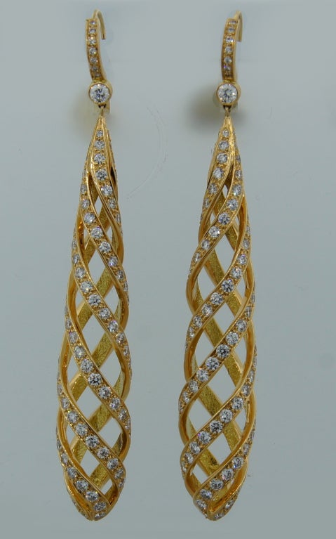 Fabulous - feminine and elegant dangling earrings created by Paloma Picasso for Tiffany & Co. Made of yellow gold and studded with round diamonds.
