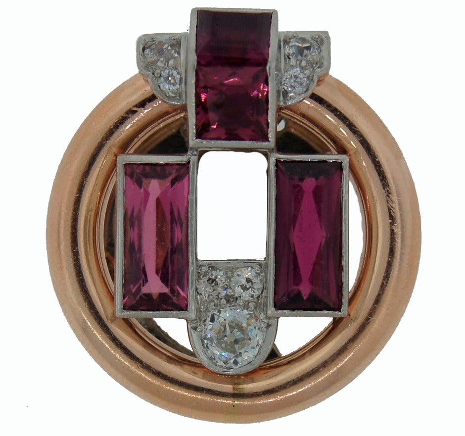 Gorgeous Art Deco single clip/brooch/pin created by Cartier in the 1920's. Beautiful, very Art Deco geometrical design. Elegant combination of colors. Thoughtful selection of the stones and rose gold.
Two emerald cut and two table cut pink