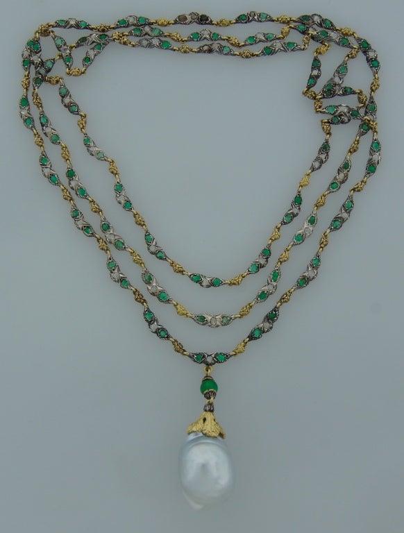 Fabulous necklace created by Buccellati in Italy in the 1970's.
Features a grayish-white lustrous 23.26 x 16.20 mm Baroque pearl. The necklace part is made of yellow and white gold set with rose cut diamonds and emeralds.
The necklace is 39.5