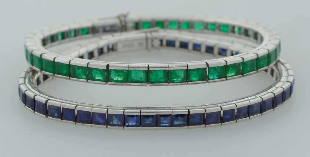 A pair of fabulous platinum tennis bracelets created in the 1920-30's. One bracelet features 48 table cut sapphires (total weight approximately 12.38 carats). The other one features 41 table cut emeralds (total weight approximately 9.02 carats). The