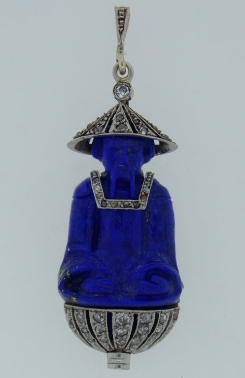 Amazing inspired by Asian motifs pendant created by Lacloche in France in the 1920's. Fine carving on lapis lazuli, tasteful diamond accents, perfect proportions, beautiful design make this pendant a conversational piece.
Signed. French hallmarks