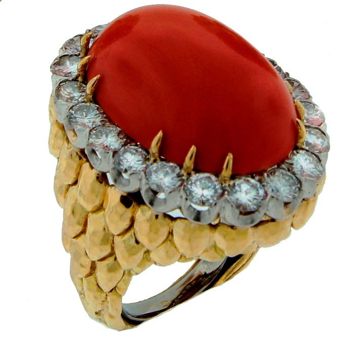 Stunning bold and colorful ring created by David Webb in the 1980's. Elegant and chic!
Features an elegant oval cabochon coral framed with round brilliant cut diamonds. Diamond total weight 3.32 carats, the coral measures 24.30 x 16.77 x 7.68 mm.