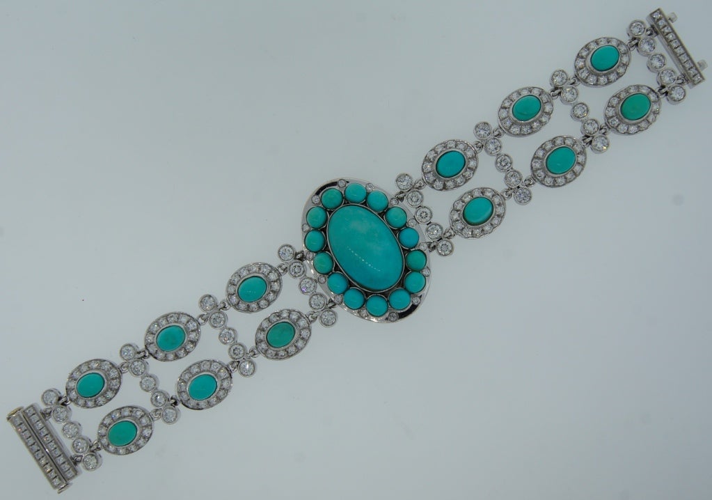 Elegant and feminine bracelet featuring an oval cabochon Persian turquoise and round brilliant cut diamonds set in 18 karat white gold. Diamonds are F-G-H color, VS clarity, approximately 9.88 carats total.
Measurements: 7-1/4 x 1 inches (18 x 2.5