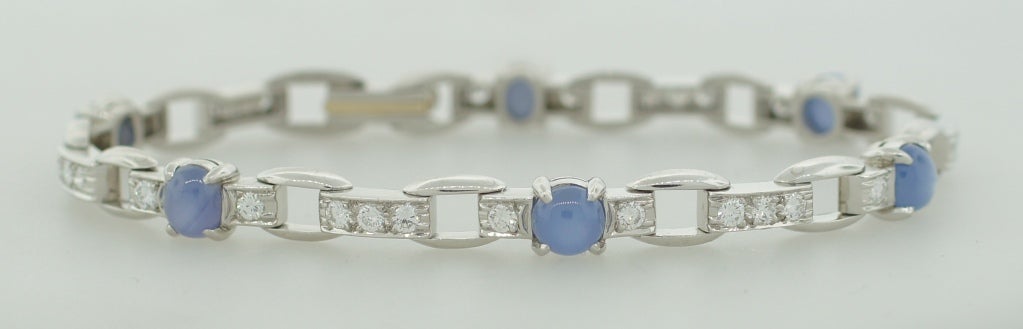 Delicate feminine bracelet created by J.E. Caldwell in the 1960's. Features six star sapphires accented with round diamonds set in platinum.
Fits up to 6.5