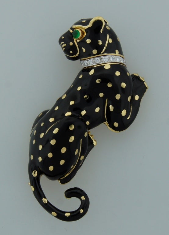 Bold and chic panther pin created by David Webb in the 1970's. 
Gracious panther posture, outstanding workmanship on enamel, tasteful diamond collar and accented with an emerald panther's eye - are the highlights of this fabulous piece. The