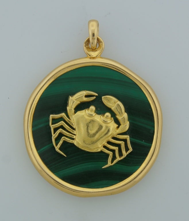 Fabulous colorful pendant created by Van Cleef & Arpels in Paris in the 1970s. Inspired by Astrological Zodiac motifs and features a cute gold cancer sitting on a malachite disc. The disc is 1-7/8