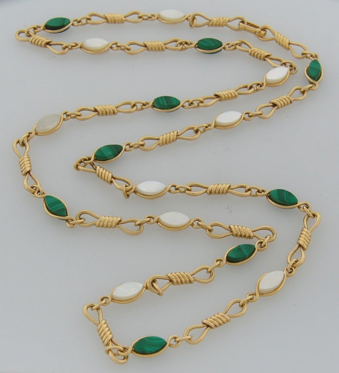 Fabulous colorful necklace created by Van Cleef & Arpels in Paris in the 1970s.  It is made of 18k yellow gold and features malachite and mother-of-pearls marquises. 
The necklace is 30 inches (76cm) long. Wight 48.6 grams.
Stamped with French