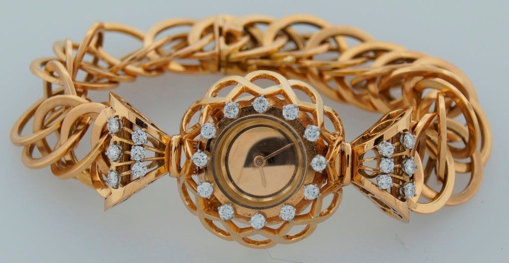 Chic and feminine Retro watch created by Boucheron in the 1940s. Made of 18k yellow gold and set with twenty four round diamonds of total weight approx. 1.20 carats. The watch fits up to 6.5