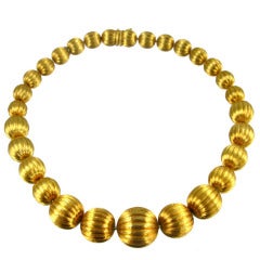 A Gold Bead Necklace With a Florentine Finish