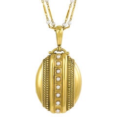 An Antique Gold Locket With Applied Wire Work and Pearls