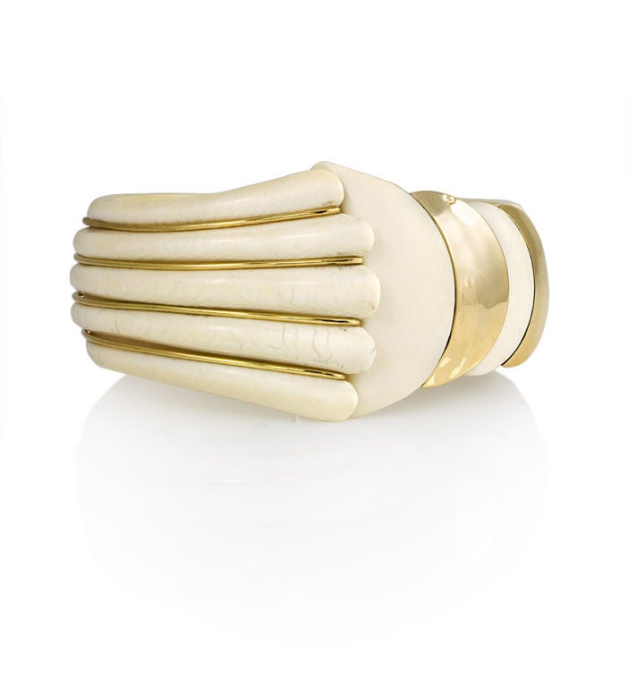 A Retro gold and carved ivory cuff bracelet of ribbed and overlapping design, 18k France.