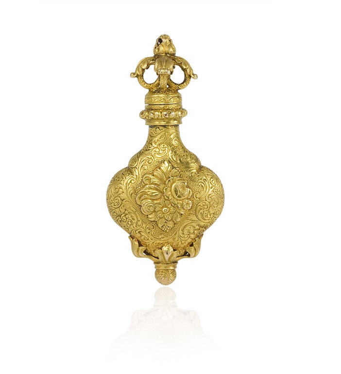 An antique gold perfume pendant with chased and engraved foliate decoration, in 18k.