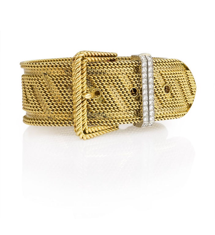 A woven gold bracelet of buckled design with a two-row diamond closure, in 18k. Approximate total weight: 1.0 carats, Clarity: VVS2-VS1, Color: F-G. A. Vassort for Cartier, Paris.