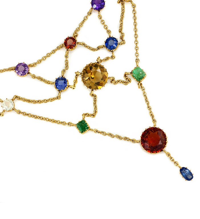 An antique colored stone bib necklace of festoon design, set with sapphires, emeralds, amethysts, white sapphires, citrines and garnets, in 18 carat gold.