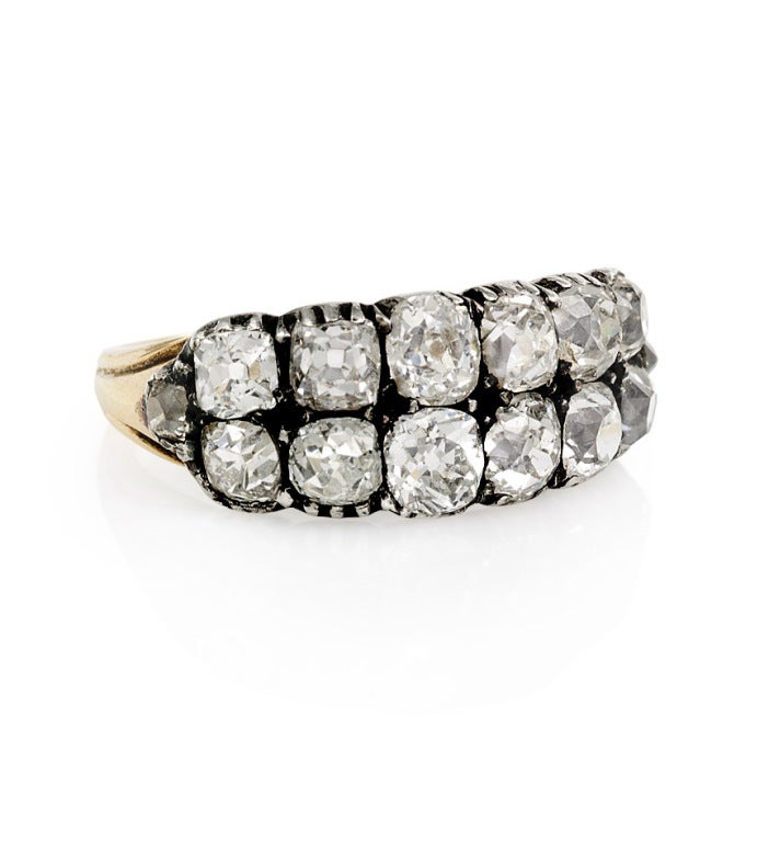 An antique diamond ring comprised of two rows of old mine cut diamonds, in sterling silver and 18k gold. Approximate total weight: 1.50 carats, VS1/VS2.
**Can be sized**
