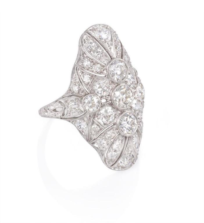 An Edwardian diamond ring with filigreed lozenge-shaped top and chased shank, in platinum.  Atw 2.85 cts.