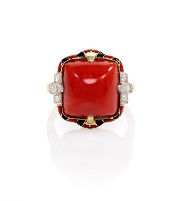 An Art Deco coral ring with red and black enamel decoration and diamond accents, in 14k gold and platinum.  Signed FFF.