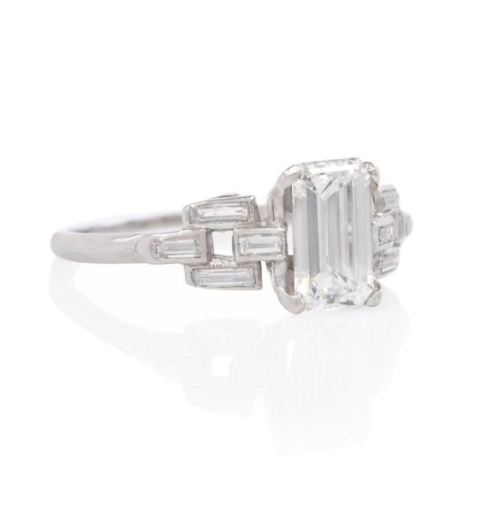 An Art Deco emerald-cut diamond engagement ring in a tapering link motif setting, in platinum.  Atw 1.01 ct., F/G color, VS1 clarity.  EGL certificate.