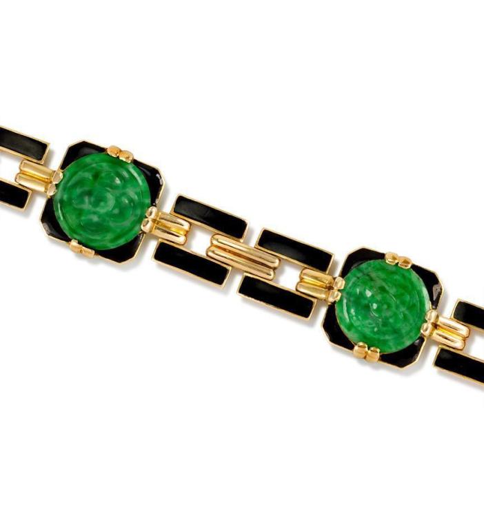 An Art Deco bracelet comprised of gold and black enamel links set with four carved circular jade panels, in 18k.  Georges L'Enfant, Paris.  #B787