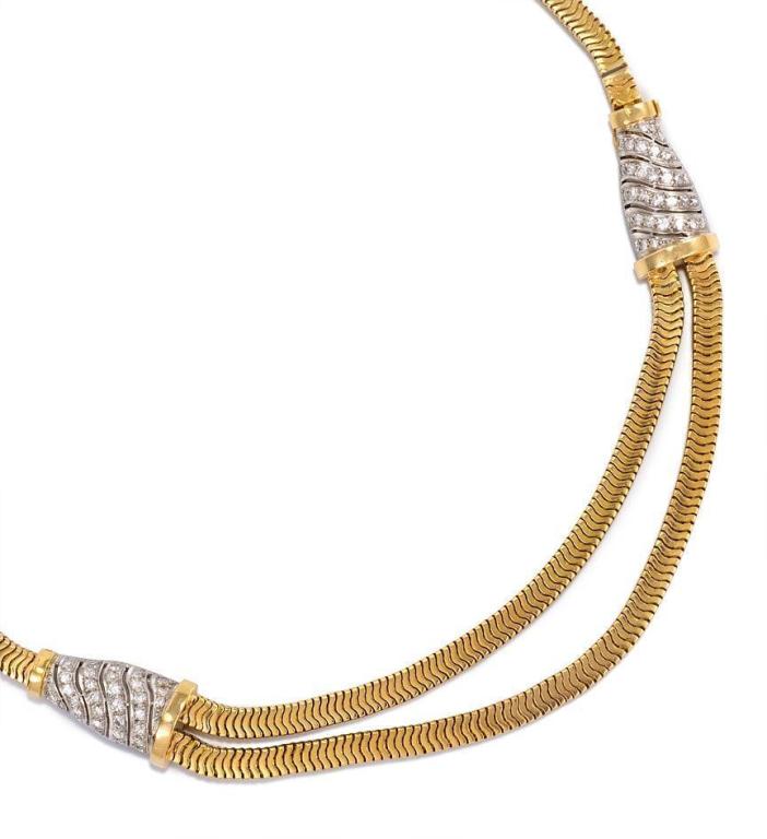A Retro gold and diamond necklace of flat Brazilian chain with two tapered diamond lozenges suspending a double nesting chain, in 18k and platinum. France.