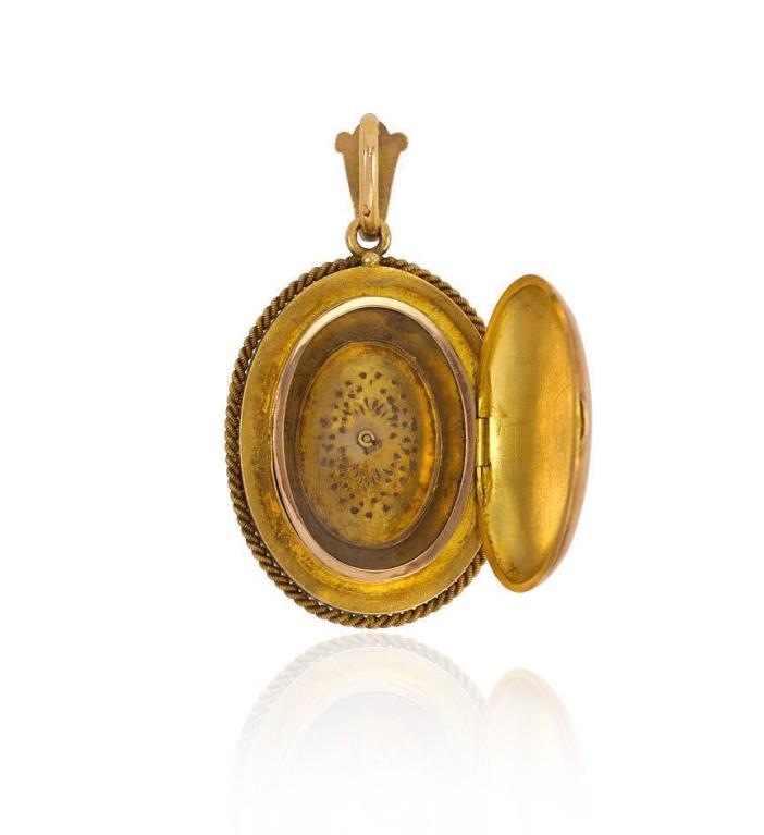 An antique oval gold locket with a sugar-loaf turquoise surround and a pearl center, in 18k.  France.