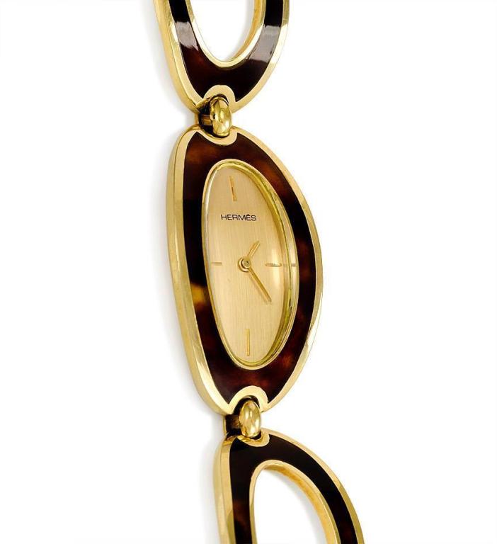 Hermes lady's 18k yellow gold and enamel bracelet watch with curved oval links, the enamel colored to simulate tortoise shell. No. 57705.