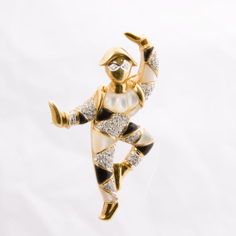 18kt. yellow gold Harlequin pin set with black onyx, and mother of pearl, bead set in white gold with 72 round brilliant cut diamonds totaling approx 1.ct. grading VS clarity G color