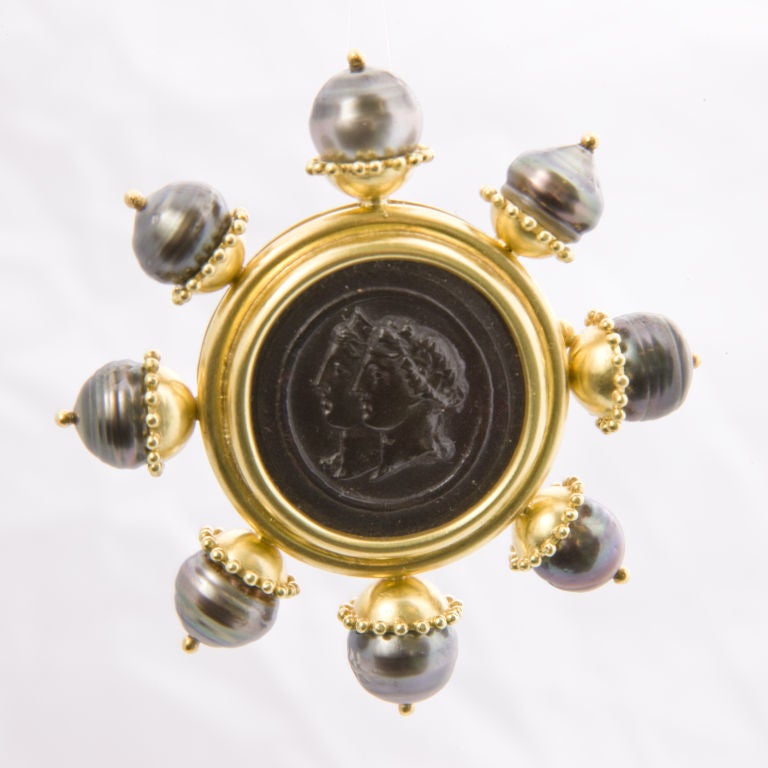 18kt. double bust center brooch, with 8 baroque grey pearl spokes each meas. approx.11 mm., double clip back, signed