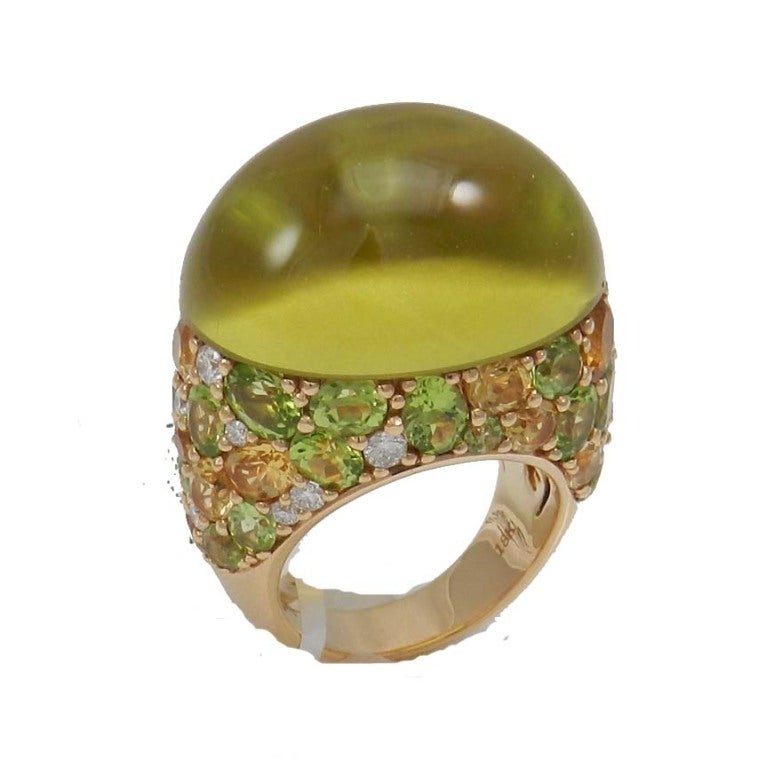 Stunning 18kt. yellow gold heavy mount citrine cabochon ring, sprinkled on the mount with 24 round and oval natural fine color peridots is various sizes totaling approx. 7.5 cts,15 round and oval faceted natural citrines totaling approx.3.5 cts.,