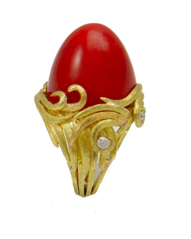 18kt. yellow gold handmade M. Buccellati oxblood coral ring, set with an important size bullet shape natural coral center measures 15.6 mm. deep , 18.4 mm. wide, with 5 round brilliant cut diamond accents totaling approx. .25 cts. the ring is size 6