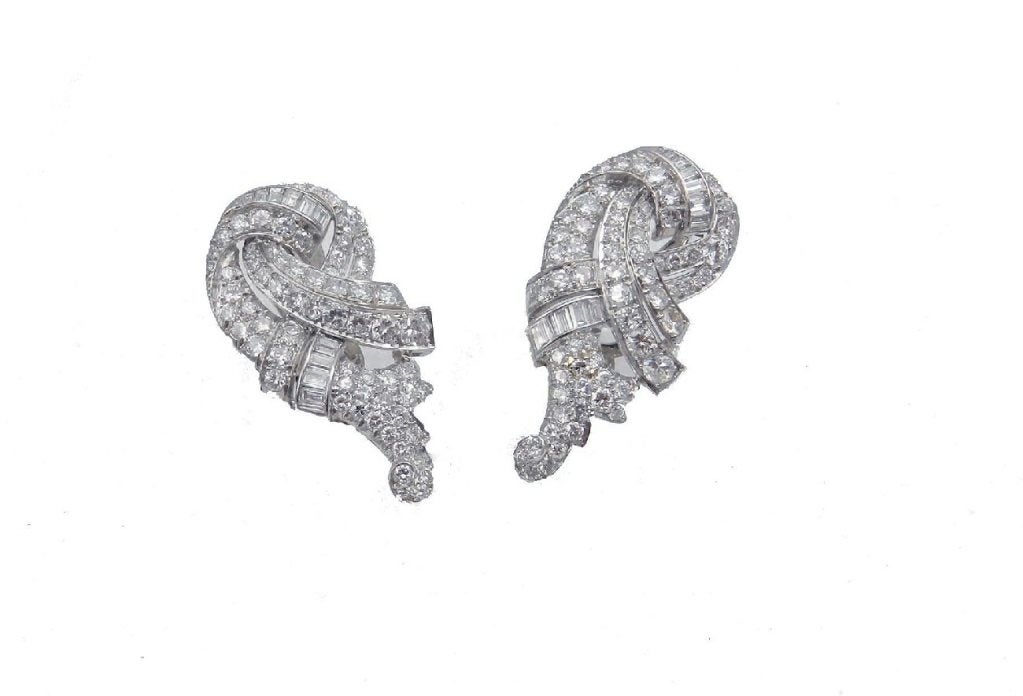 Lovely pair of handmade platinum mount of diamond clips, each clip is bead and channel set with 66 round brilliant cut diamonds and 11 baguette cut diamonds totaling approx. 7 cts. grading VS clarity G color, may be worn separately or with the